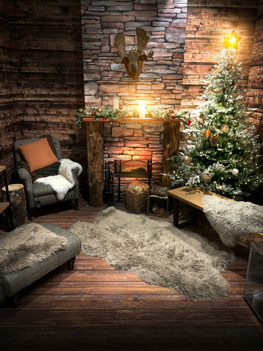 photo of a cosy looking fire hung with Christmas stockings