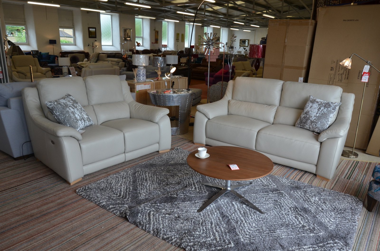 a pair of Italian leather sofas in cream with electric recliners, called the Degano or Triumph model