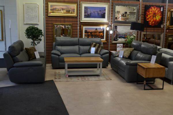 cheap Italian leather sofas in dark grey leather on display in a furniture showroom in Lancashire