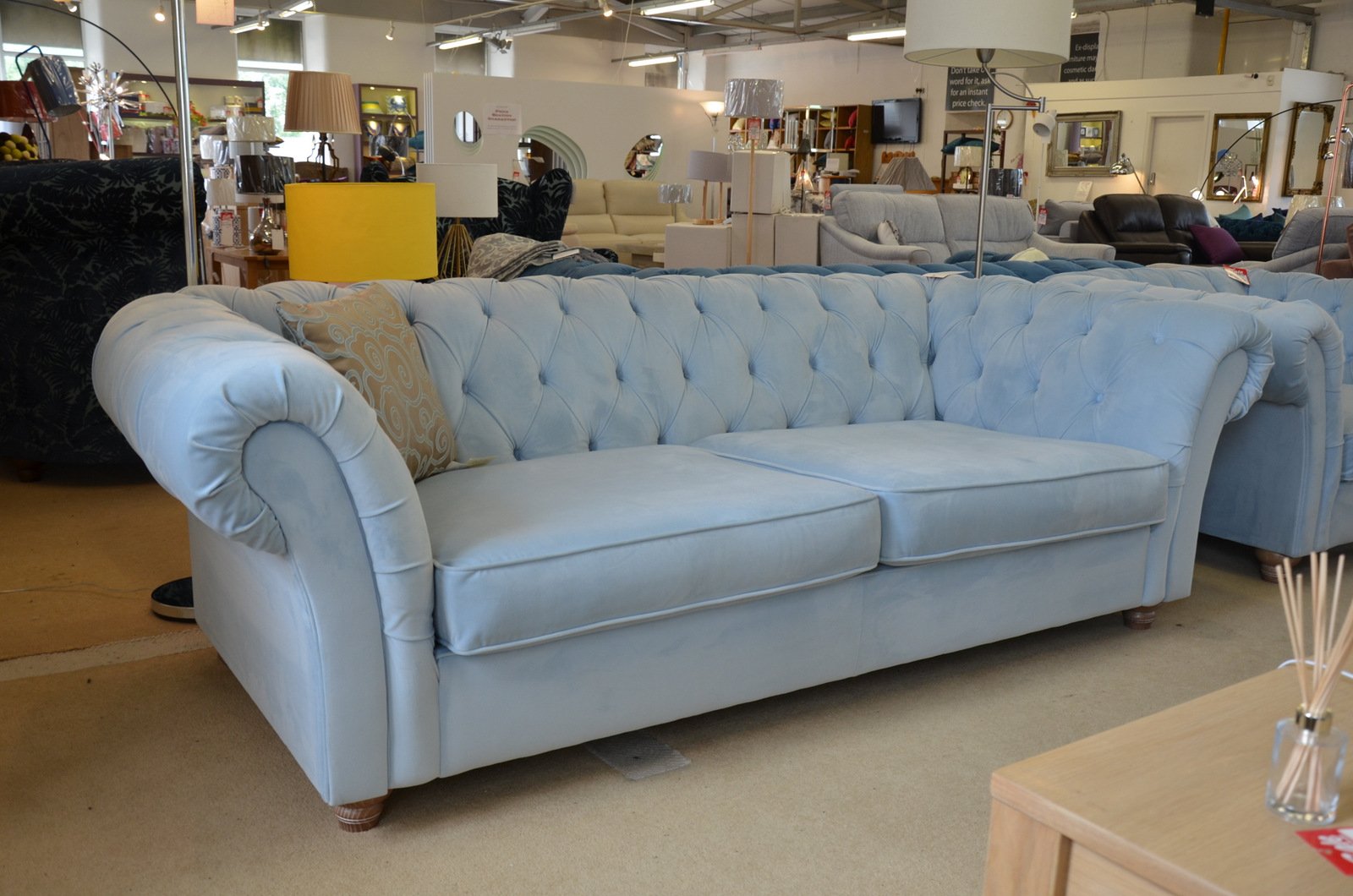 A photo of a pale blue velvet Maddox Chesterfield sofa and matching armchair